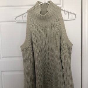 Knitted turtleneck sweater with shoulder cutouts.